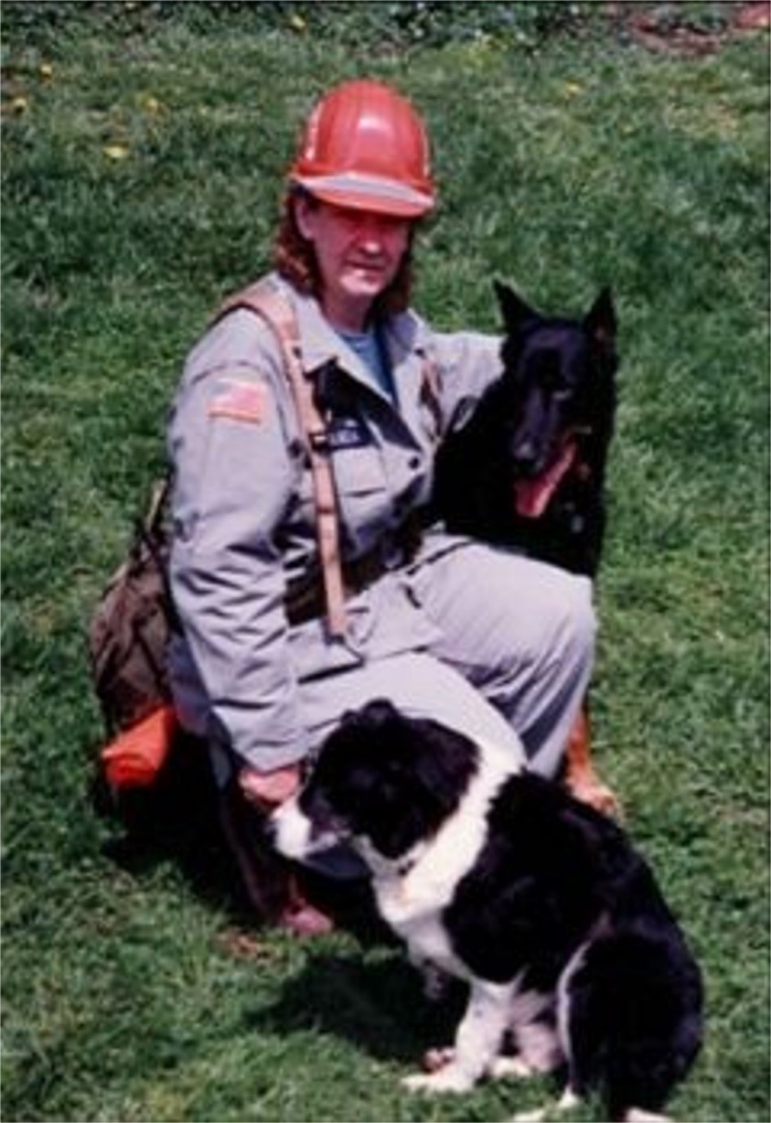 Susan Bulanda prepares for a search. With her is Scout, a black Beauceron and Ness, a black and white Border Collie. Scout and Ness were the first of their breed to do SAR in the US.