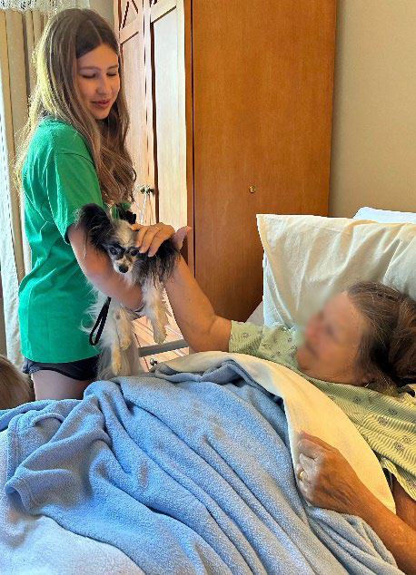 Harper and her Papillion ”assistant” visit a bedbound nursing home resident